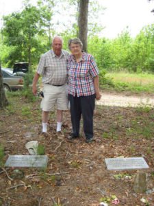 Bill and Jane Maxwell at the graves of Ephraim S. Hampton and Lemenda K. Hampton.